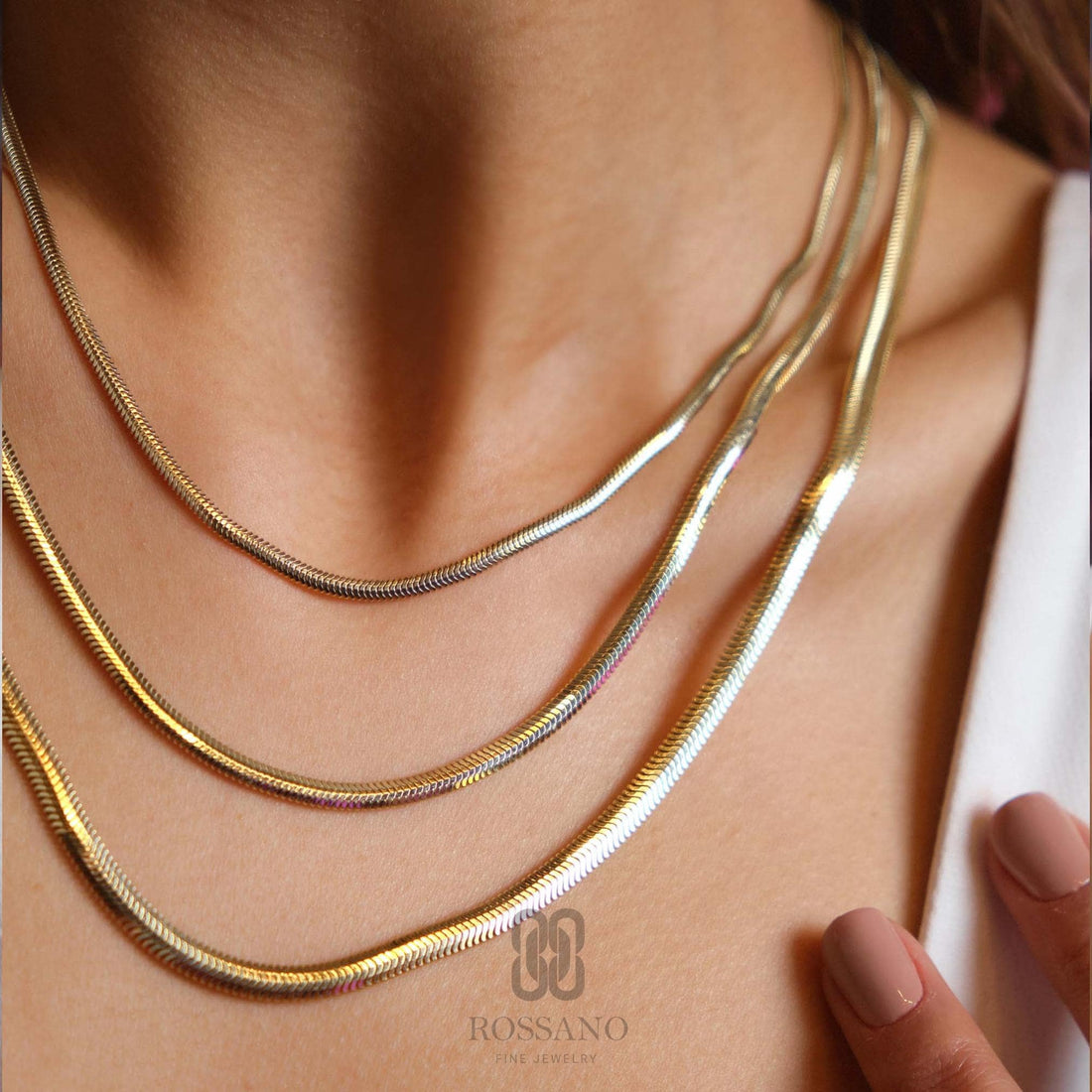 A polished 14K gold Italian herringbone chain choker